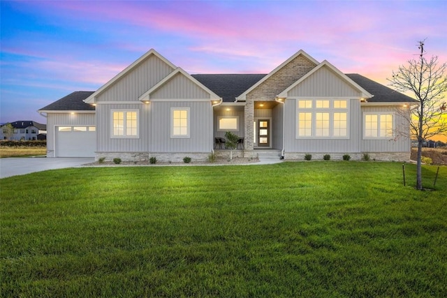 view of front of property featuring a garage and a lawn