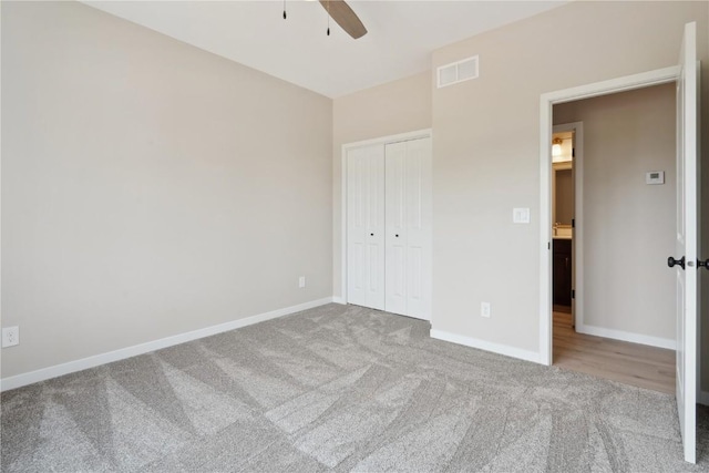 unfurnished bedroom featuring carpet, a closet, and ceiling fan