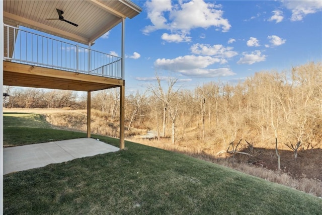 view of yard featuring a patio, ceiling fan, and a wooden deck