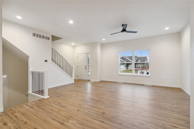 unfurnished living room featuring ceiling fan and light hardwood / wood-style flooring