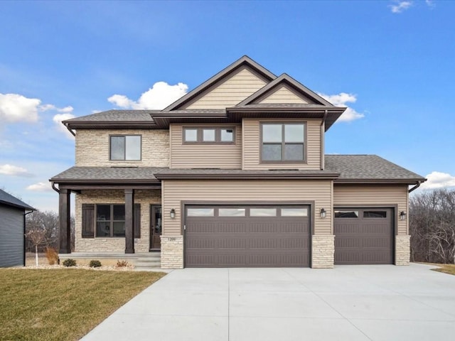 craftsman inspired home featuring a front lawn and a garage