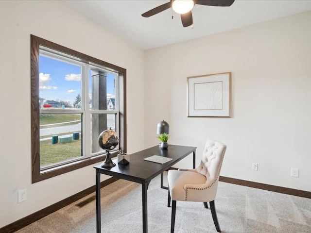 carpeted office featuring plenty of natural light and ceiling fan