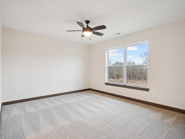 unfurnished room featuring ceiling fan and light colored carpet