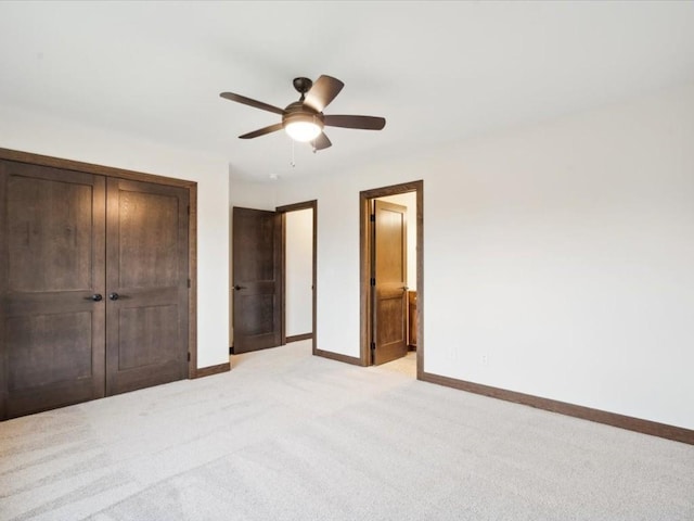 unfurnished bedroom featuring light colored carpet and ceiling fan