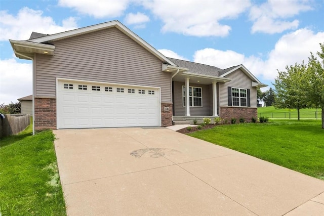 view of front of home with a garage and a front lawn