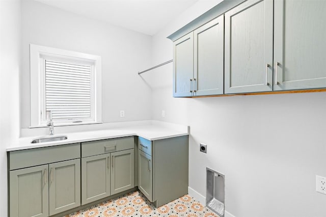 laundry room with cabinets, electric dryer hookup, and sink