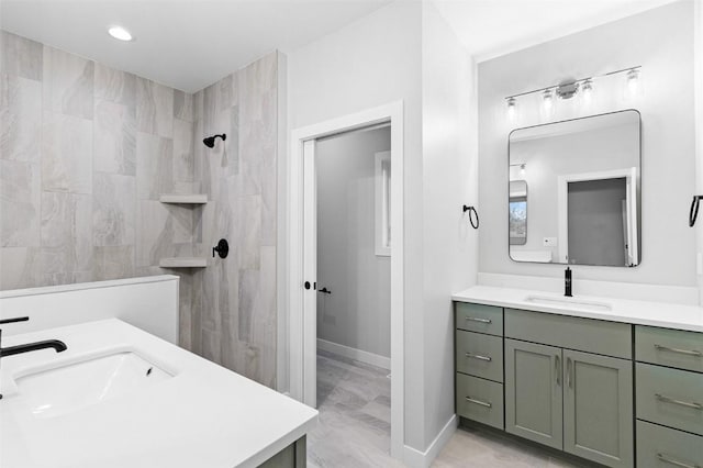 bathroom with vanity and tiled shower