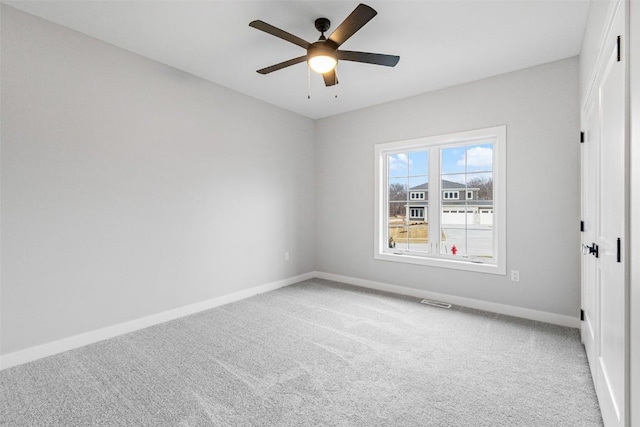 carpeted empty room with ceiling fan