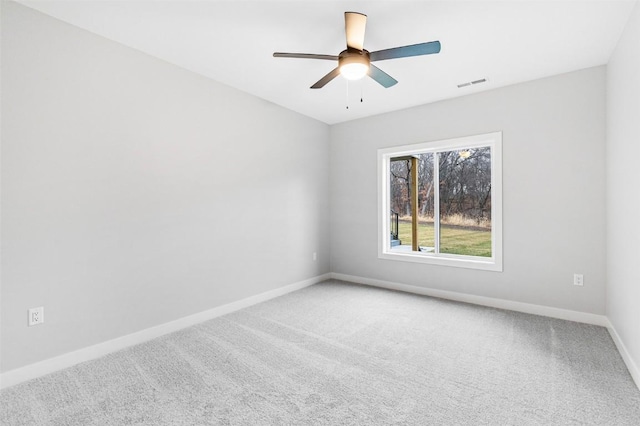 spare room featuring carpet and ceiling fan