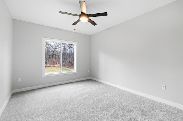 carpeted empty room featuring ceiling fan