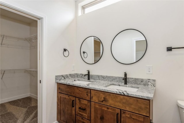 bathroom with vanity and toilet