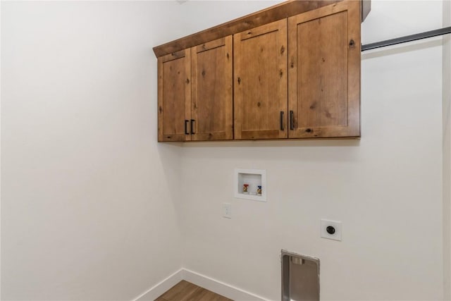 laundry area featuring hookup for an electric dryer, cabinets, wood-type flooring, and washer hookup