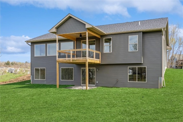 rear view of property featuring a lawn, ceiling fan, and a patio