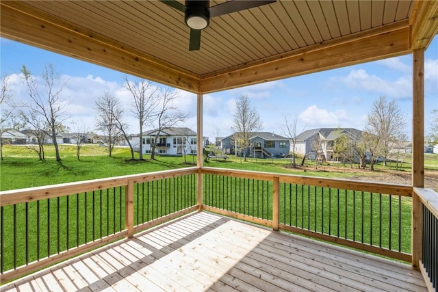 deck with a lawn and ceiling fan