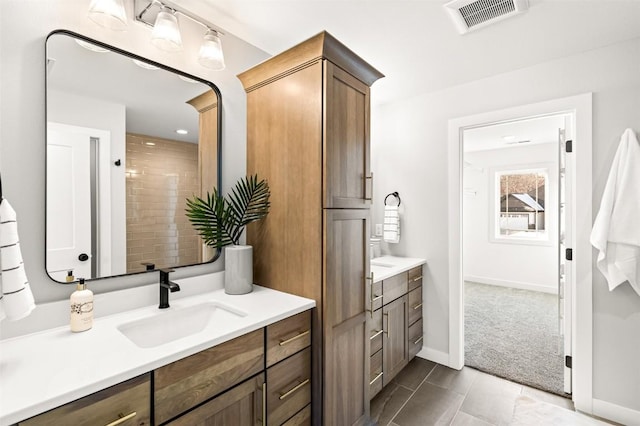 bathroom with tile patterned floors and vanity