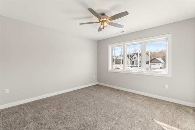 carpeted empty room featuring ceiling fan