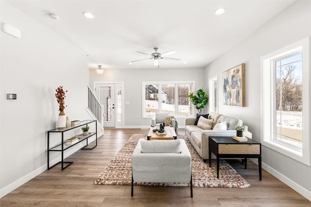 living room with hardwood / wood-style flooring, ceiling fan, and a healthy amount of sunlight