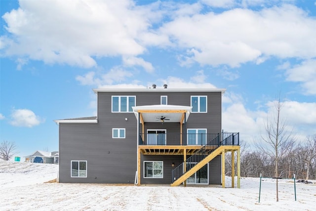 snow covered property with a deck and ceiling fan