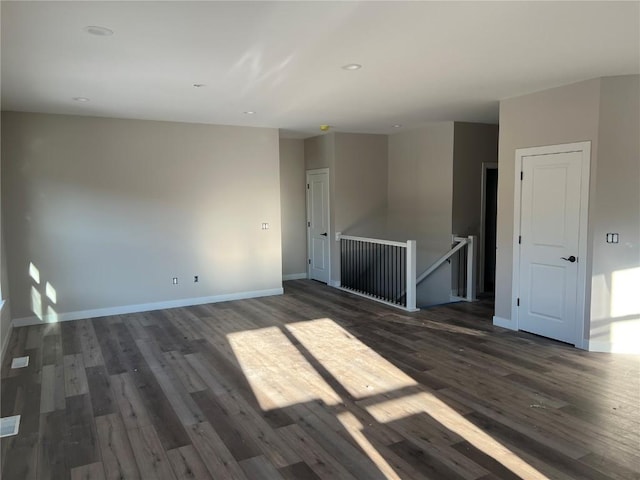 spare room featuring dark hardwood / wood-style flooring