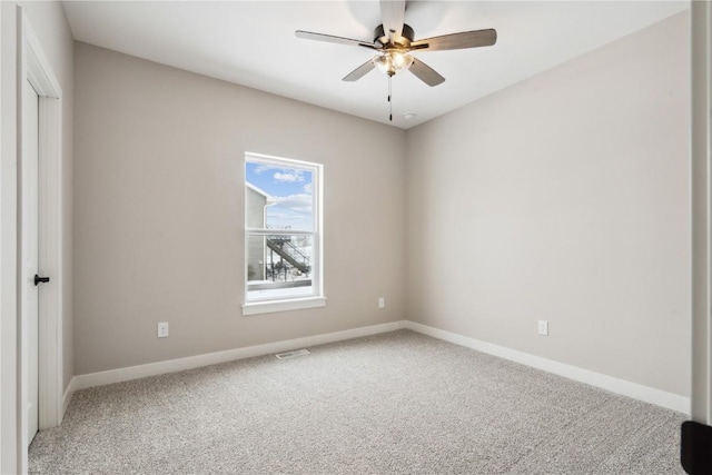 carpeted spare room with ceiling fan