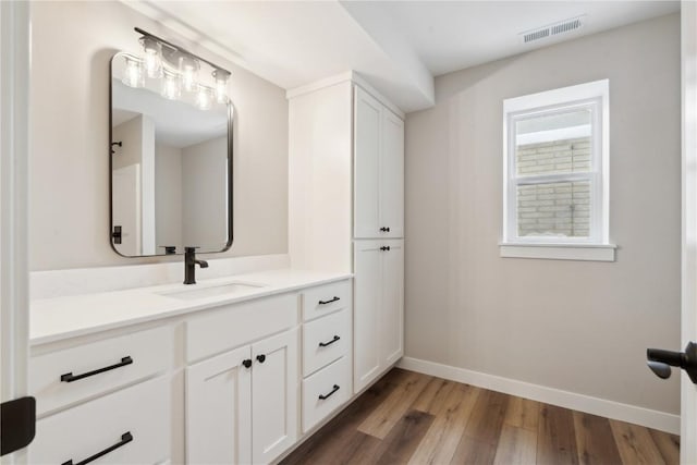 bathroom with vanity and hardwood / wood-style floors