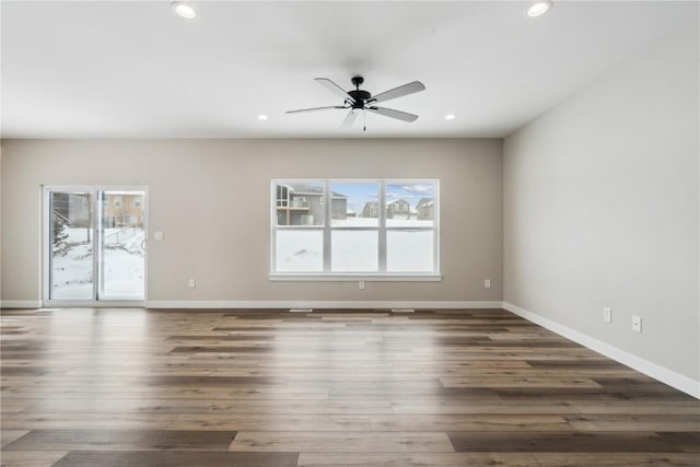 spare room with ceiling fan and dark hardwood / wood-style floors