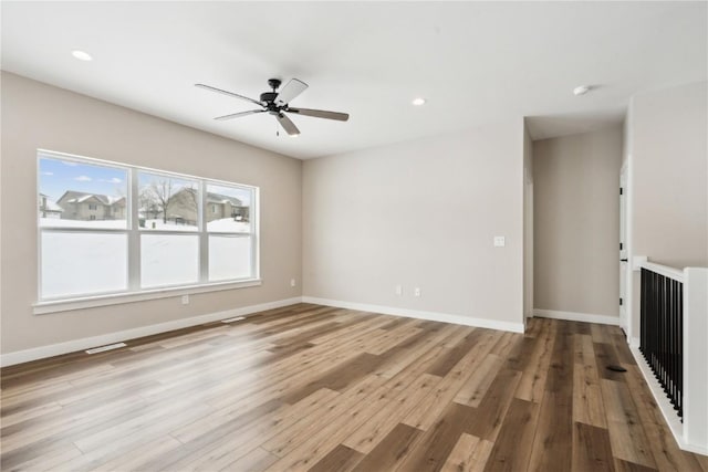 unfurnished living room featuring ceiling fan and light hardwood / wood-style flooring