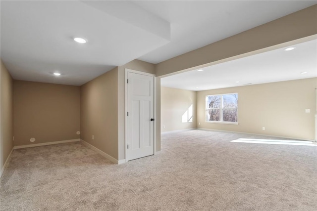 basement featuring light colored carpet