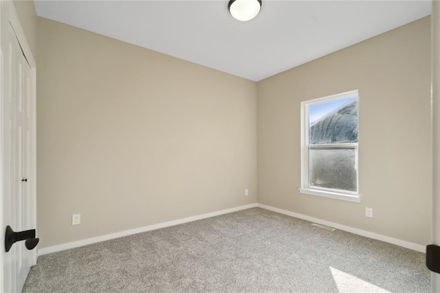 unfurnished room with light colored carpet