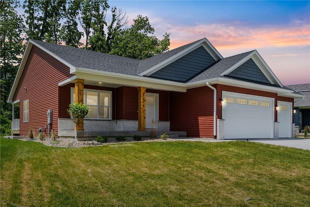 view of front of house featuring a yard and a garage