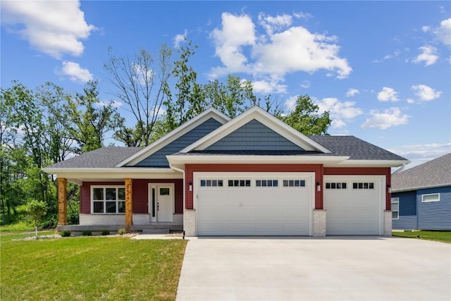 view of front of property featuring a front yard, a porch, and a garage