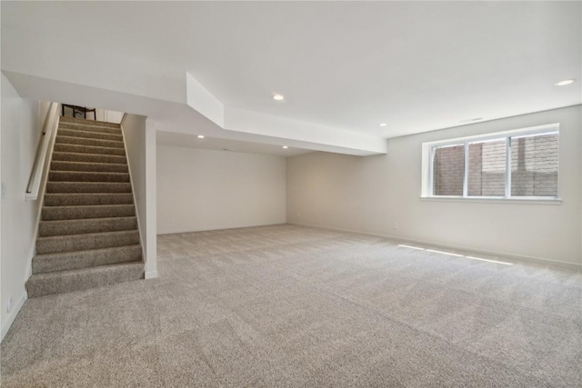 basement featuring light carpet