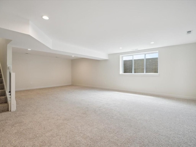 261 Colchester Dr, Iowa City, IA 52245 - below grade area with stairs, recessed lighting, light carpet, and baseboards
