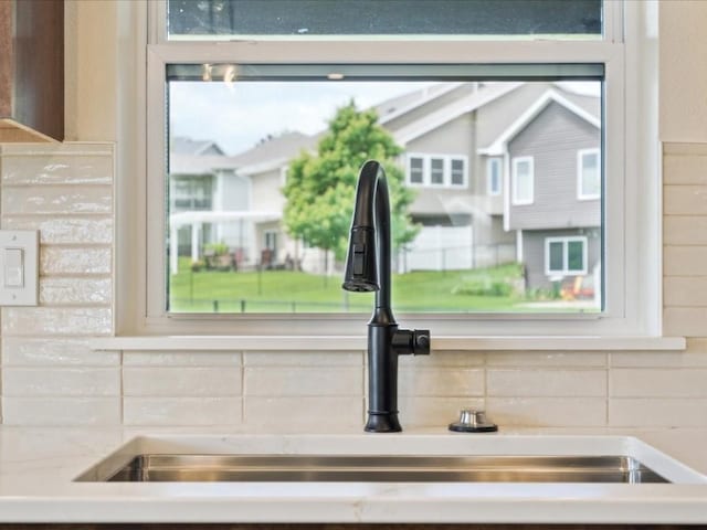 261 Colchester Dr, Iowa City, IA 52245 - kitchen view of a sink, decorative backsplash, and light countertops