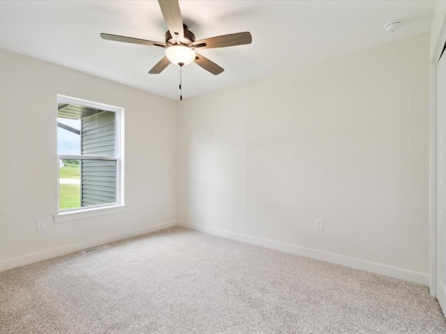 261 Colchester Dr, Iowa City, IA 52245 - unfurnished room featuring light carpet, a ceiling fan, and baseboards