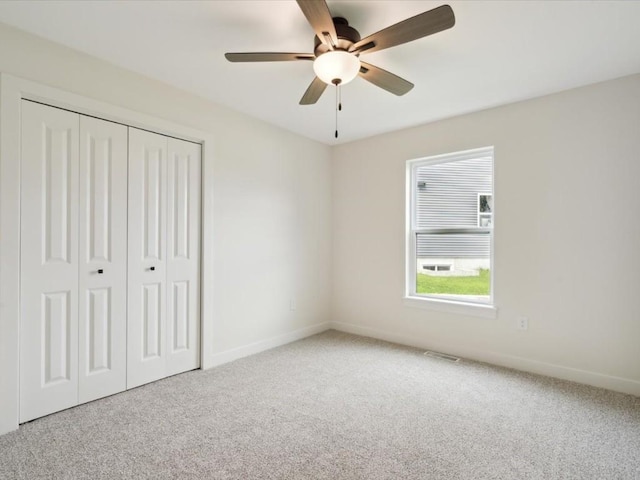 261 Colchester Dr, Iowa City, IA 52245 - unfurnished bedroom featuring carpet floors, a closet, baseboards, and a ceiling fan