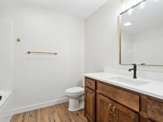 261 Colchester Dr, Iowa City, IA 52245 - bathroom featuring vanity, wood finished floors, toilet, and baseboards