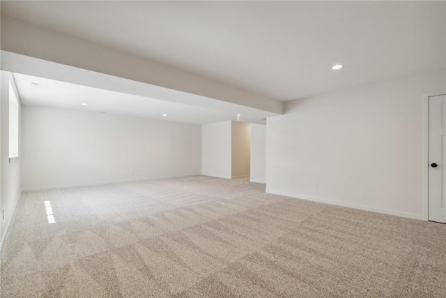 basement featuring light carpet