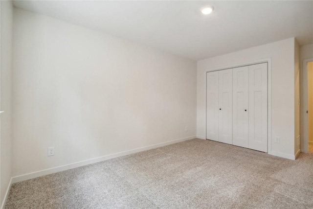 unfurnished bedroom with carpet flooring and a closet