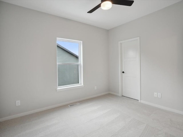 unfurnished room featuring ceiling fan and light colored carpet