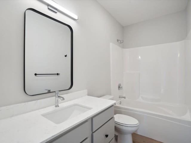 full bathroom with vanity,  shower combination, and toilet