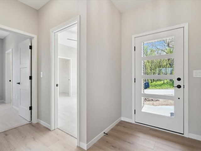 1423 Legend Dr, Tiffin, IA 52340 - doorway featuring light wood-style flooring and baseboards