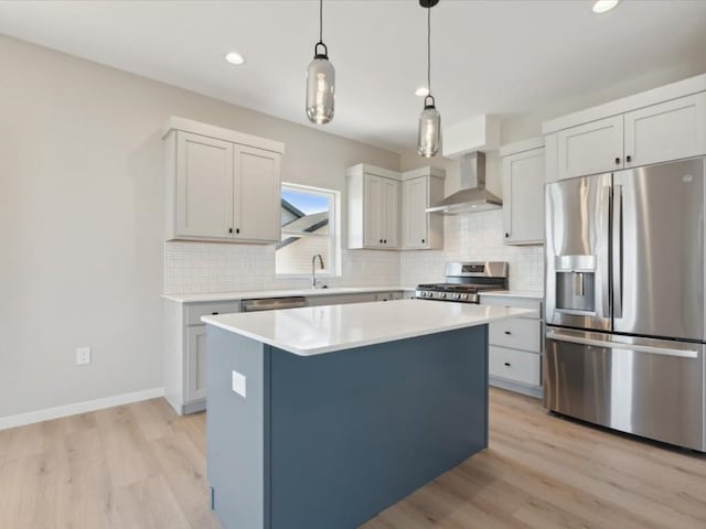 1423 Legend Dr, Tiffin, IA 52340 - kitchen featuring stainless steel appliances, wall chimney exhaust hood, light wood-style flooring, decorative backsplash, and a center island
