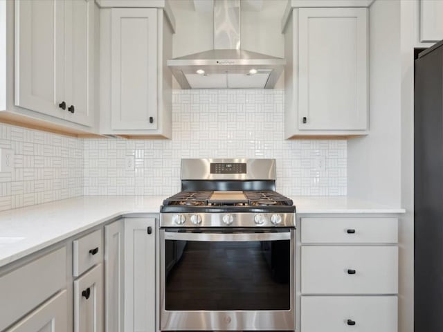 1423 Legend Dr, Tiffin, IA 52340 - kitchen featuring gas stove, wall chimney exhaust hood, light countertops, tasteful backsplash, and black refrigerator