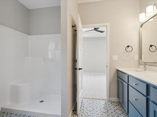 1423 Legend Dr, Tiffin, IA 52340 - full bath featuring a shower, vanity, baseboards, and tile patterned flooring