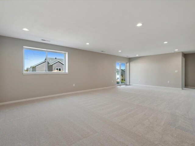 1423 Legend Dr, Tiffin, IA 52340 - empty room with recessed lighting, light colored carpet, healthy amount of natural light, and baseboards