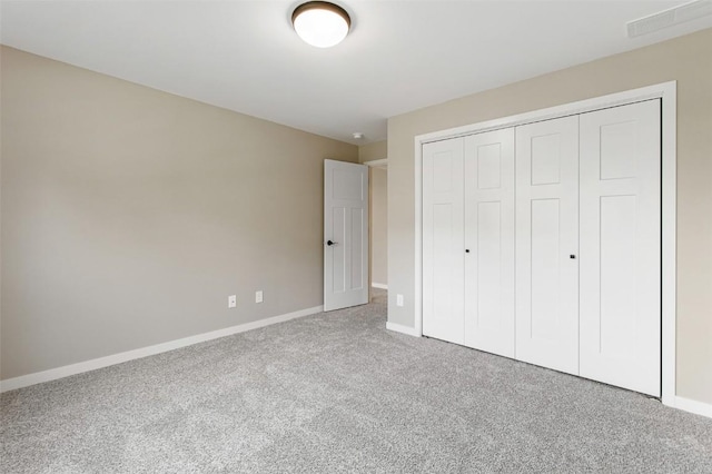 unfurnished bedroom featuring carpet floors and a closet