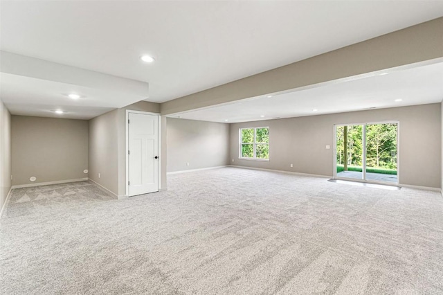 basement featuring light colored carpet