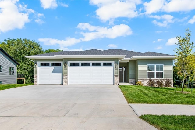 prairie-style house featuring a front yard and a garage