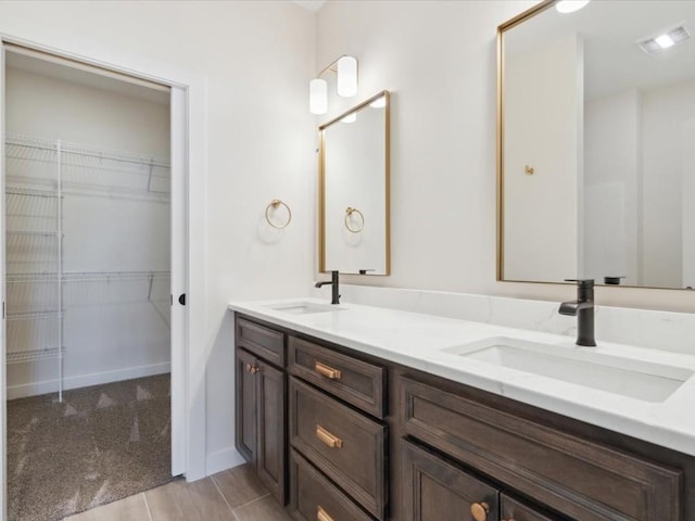 1501 Legend Dr, Tiffin, IA 52340 - full bathroom featuring double vanity and a spacious closet